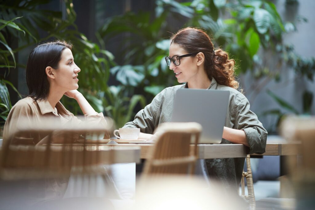 Confident ladies working on web design