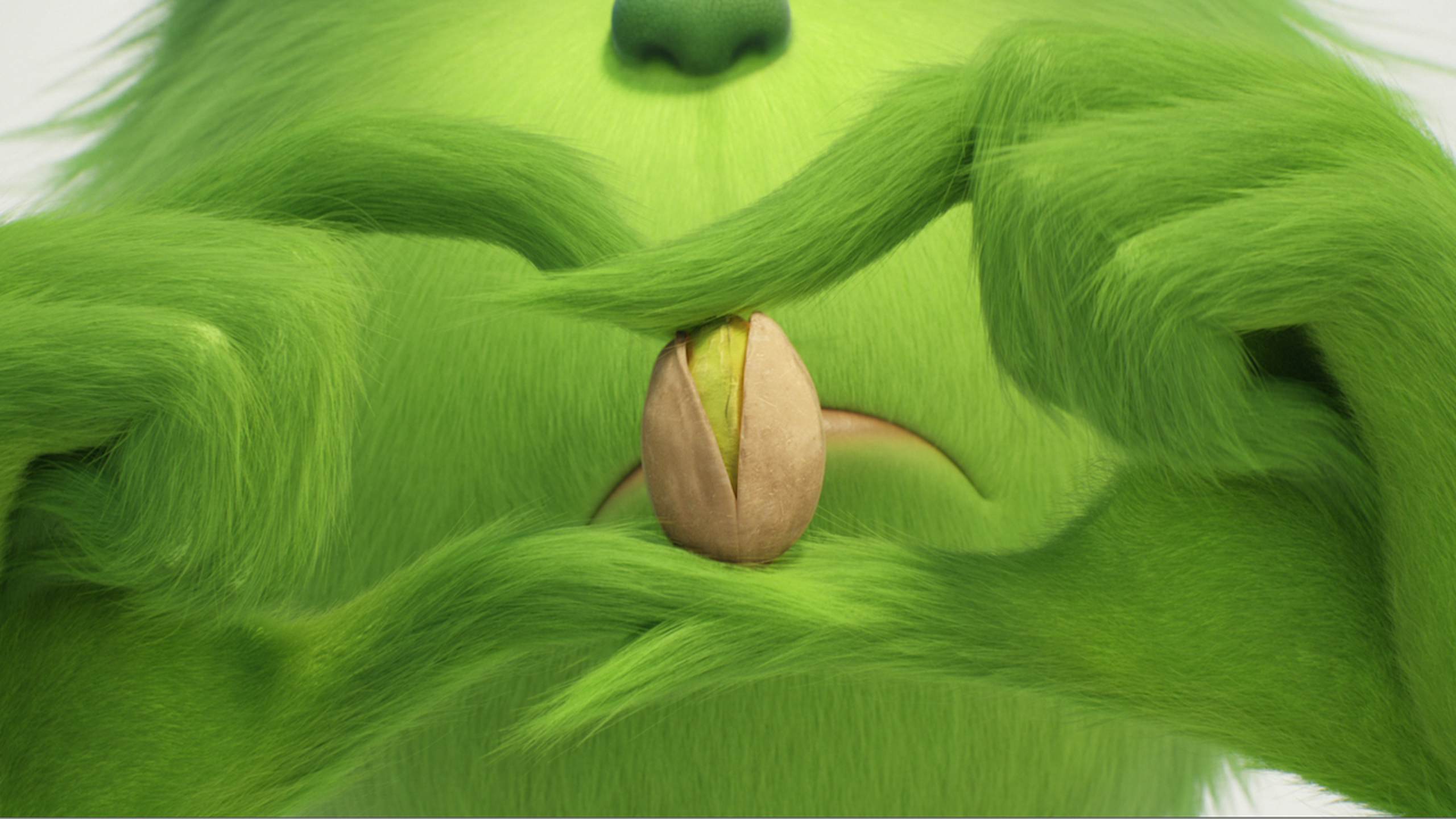 the Grinch holding a pistachio from the Wonderful Pistachios advertising campaign 